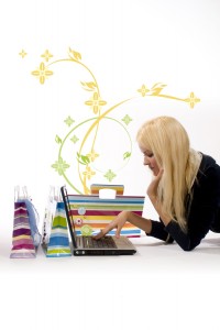 Blonde girl shopping at computer with flourishes in the air