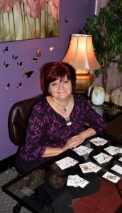 deborah leigh at her desk with cards laid out in front of her
